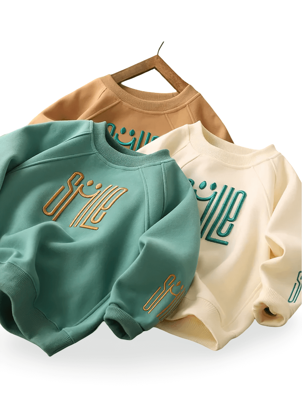 Trendy SMILE print sweatshirts for kids in mint green, beige, and stylish colors. Warm, cozy fabric with eye-catching graphics and elasticized cuffs.